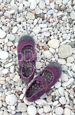 Woman shoes on the beach stones