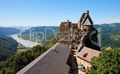 Roofs and towers of Aggstein medieval castle on Danube valley background
