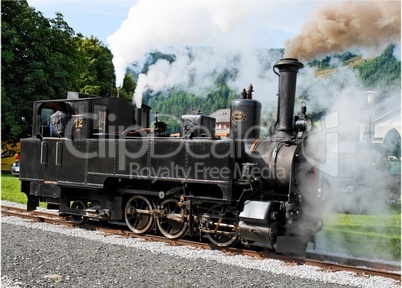Historical steam engine on tracks near Mauterndorf railway station in Austria