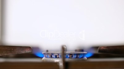 gas stove being turned on soft focus