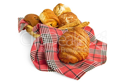 Croissant and muffins in a basket with a napkin