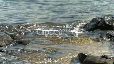 Meerwasser schwappt auf die Steine der Klippen