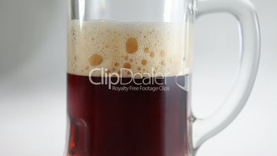 Dark Beer pour in glass beer mug closeup