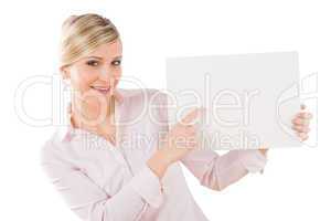 Happy businesswoman pointing aside at empty banner