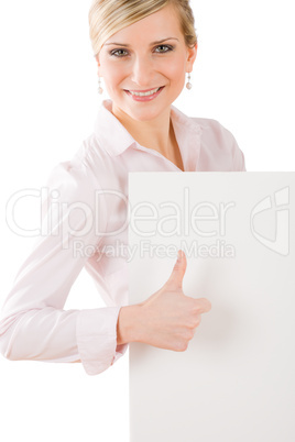 Happy businesswoman behind empty banner thumbs up