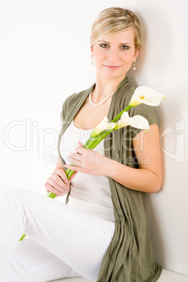 Romantic woman hold calla lily flower sitting