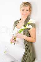 Romantic woman hold calla lily flower sitting