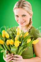 Young woman hold yellow tulips flower