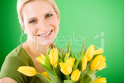 Young woman hold yellow tulips flower