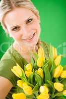 Young woman hold yellow tulips flower