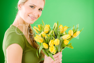 Young woman hold yellow tulips flower