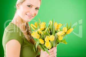 Young woman hold yellow tulips flower
