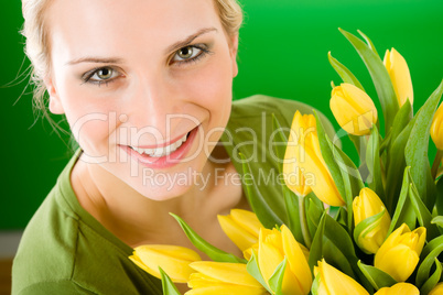 Young woman hold yellow tulips flower