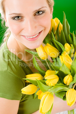 Young woman hold yellow tulips flower