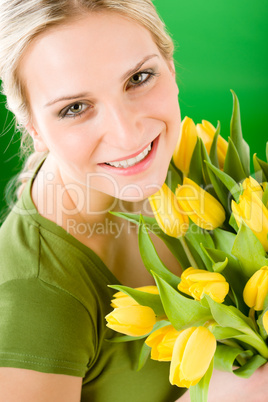 Young woman hold yellow tulips flower