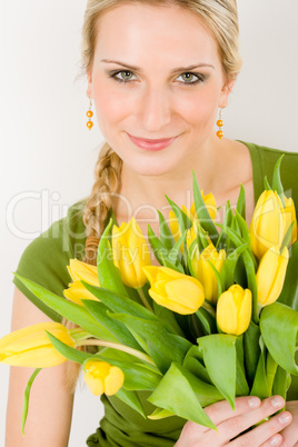 Young woman hold yellow tulips flower