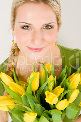 Young woman hold yellow tulips flower