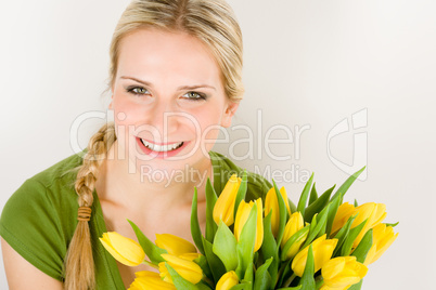 Young woman hold yellow tulips flower