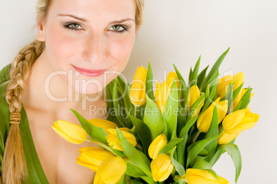 Young woman hold yellow tulips flower