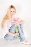 Young woman hold pink gerbera daisy flower