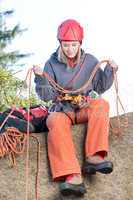 Active woman rock climbing holding rope