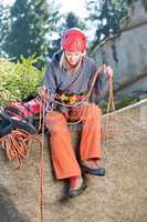 Active woman rock climbing holding rope