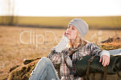 Camping young woman in countryside backpack relax