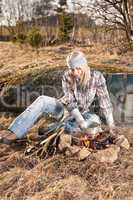 Campfire hiking woman with backpack cook country