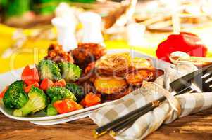 Fried potatoes broccoli carrots and roasted chicken