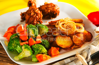 Fried potatoes broccoli carrots and roasted chicken