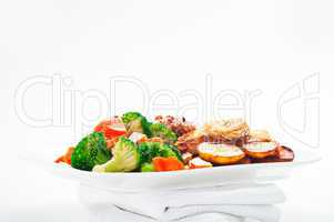 Fried potatoes broccoli carrots and roasted chicken