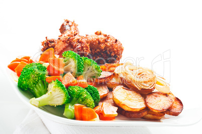 Fried potatoes broccoli carrots and roasted chicken