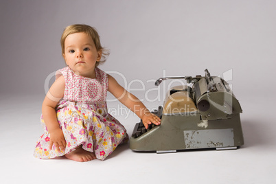 Baby Girl Posing with Typewriter