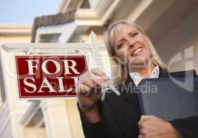 Real Estate Agent with Keys in Front of Sign and House
