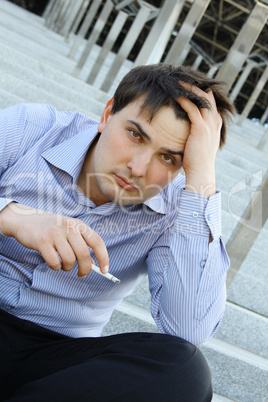 Businessman smokes