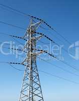 Steel support of overhead power transmission line on sky background