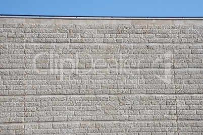 Vertical wall built of gray stone blocks