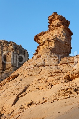 Weathered rock finger in stone desert