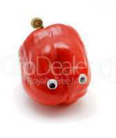Sweet red bell pepper with eyes on white background