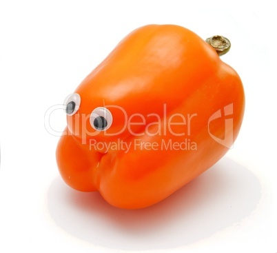 Sweet orange bell pepper with eyes on white background