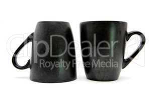 Two black coffe cups up and down isolated