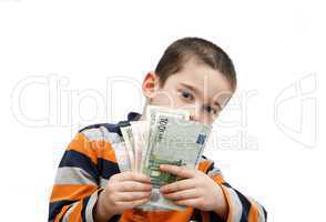 Cute little boy hides behind a fan of banknotes
