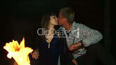 Romantic kiss near the fire