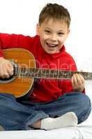 The boy with an acoustic guitar on a white background