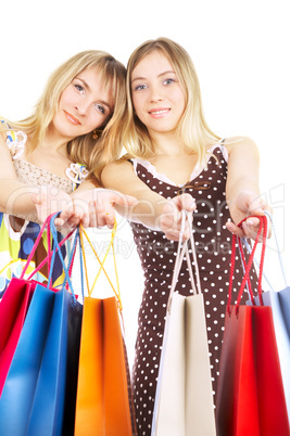 Two girls with bags - comparison shopping. Sale!