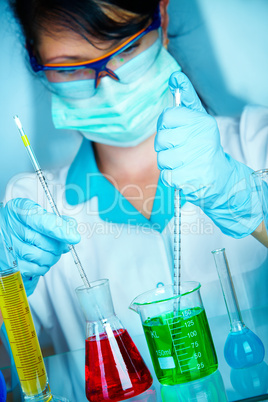 scientist in laboratory with test tubes