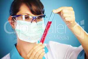 scientist in laboratory with test tubes