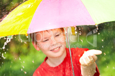 boy under an umbrella during a rain