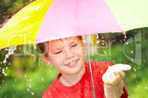 boy under an umbrella during a rain