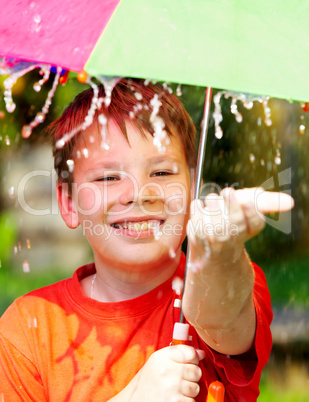 boy under an umbrella during a rain